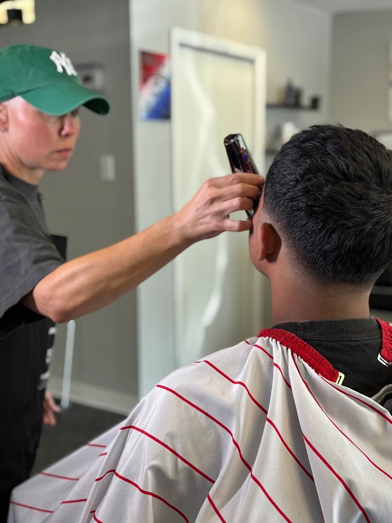 Barber detailing a client's cut with clippers