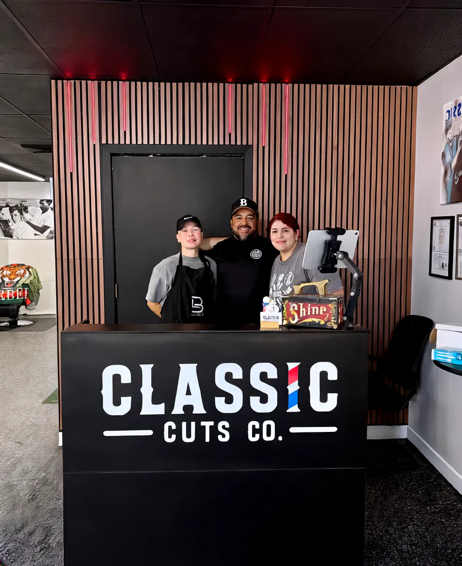 Barbers at the Classic Cuts Co. front desk